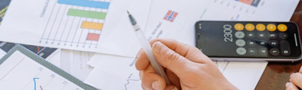 A close-up of businesspeople analyzing financial data and charts during a meeting.